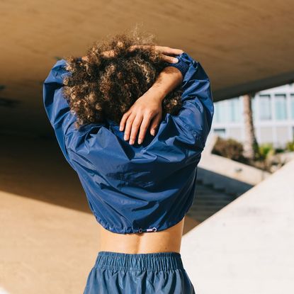 Workout exercises: A woman stretching her arms after a workout