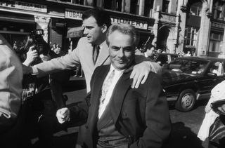 A black and white photo of John Gotti on the streets of New York