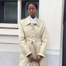 Sylvie wears a spring trench coat