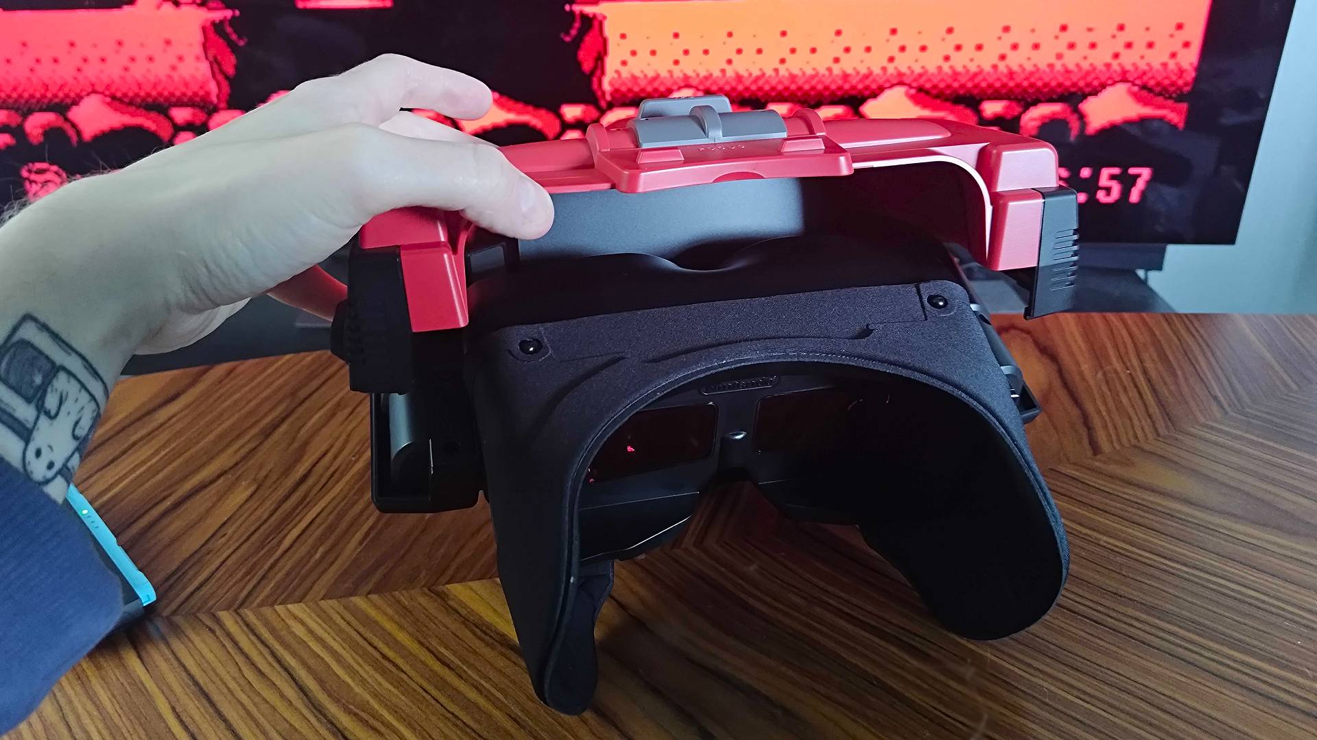 Hand opening Virtual Boy top compartment for Switch.