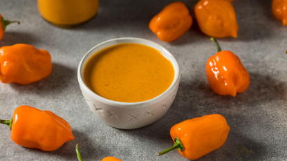 Organic Habanero Hot Sauce surrounded by chillis