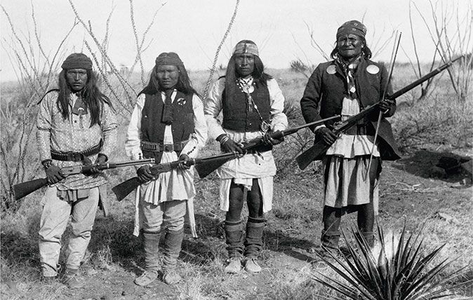 Apache chief Geronimo (far right) and three of his warriors with Winchesters