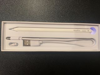 A white NovaPlus A8 Duo stylus being held in a hand and used on an iPad