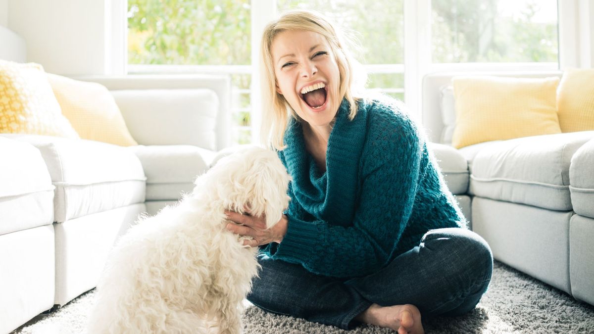 Woman in living room with a huge smile