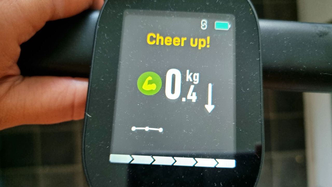 A close-up picture of the Runstar 8E SmartScan Pro displaying measurements taken during a weigh-in