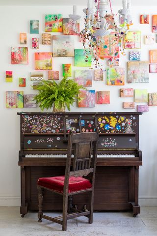 Piano in front of a wall covered in contemporary artwork