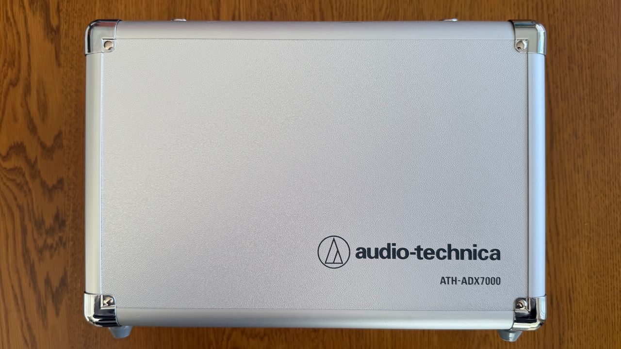 Photos of the Audio-Technica ATH-ADX7000 headphones on a wooden table