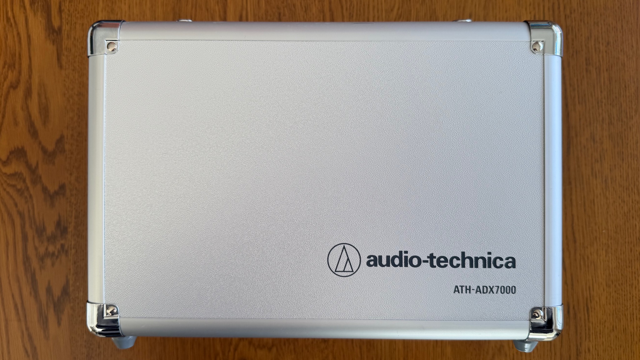 Photos of the Audio-Technica ATH-ADX7000 headphones on a wooden table