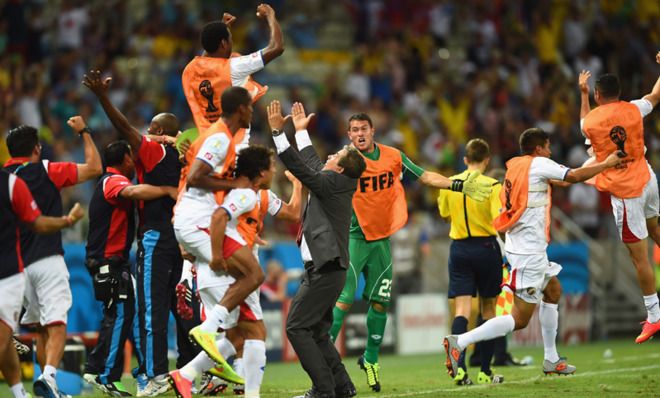 Costa Rican players celebrate their stunning upset of Uruguay in the World Cup