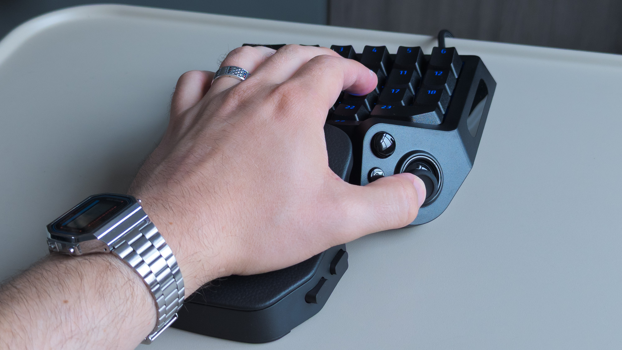 Razer Tartarus V2 Pro grasped with a hand, holding a thumbstick