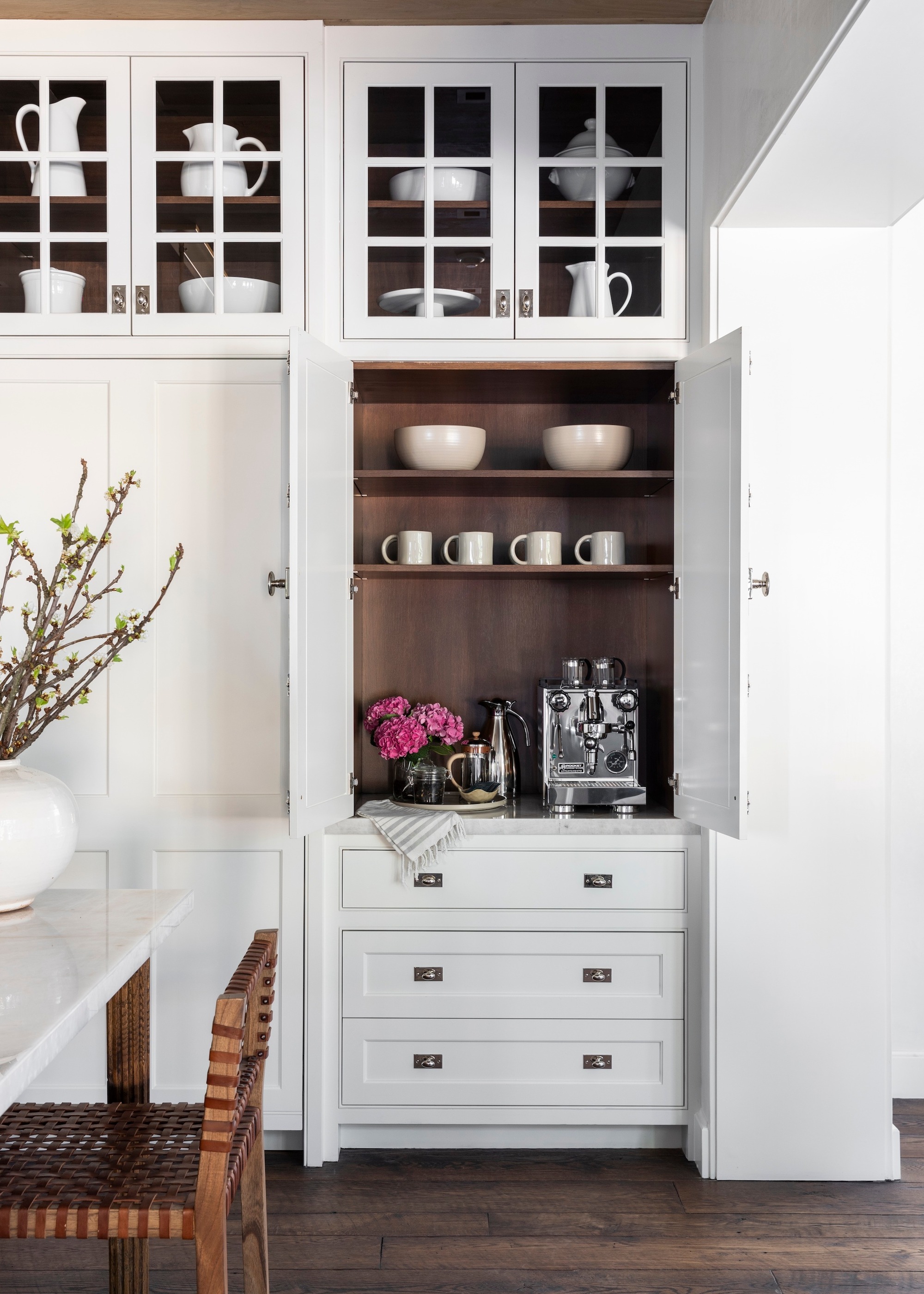 Breakfast station in white cabinetry in a white kitchen