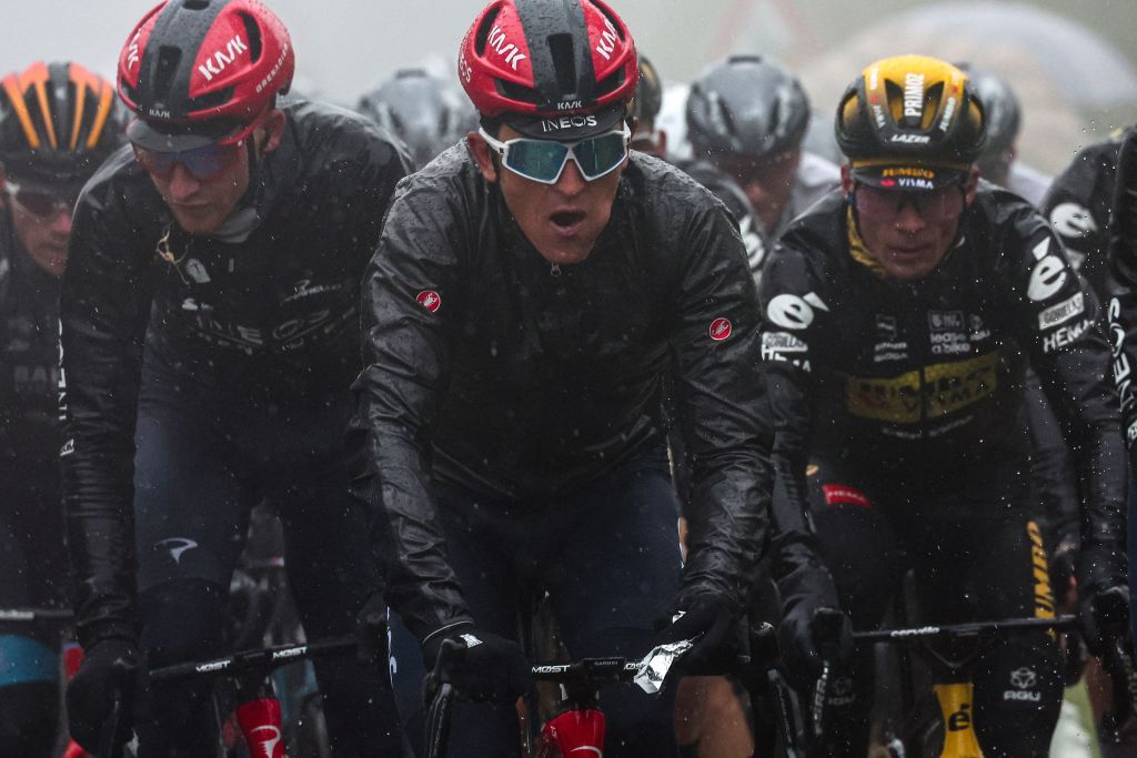 Overall leader INEOS Grenadierss British rider Geraint Thomas C and the pack of riders cycle under pouring rain during the tenth stage of the Giro dItalia 2023 cycling race 196 km between Scandiano and Viareggio on May 16 2023 Photo by Luca Bettini AFP Photo by LUCA BETTINIAFP via Getty Images