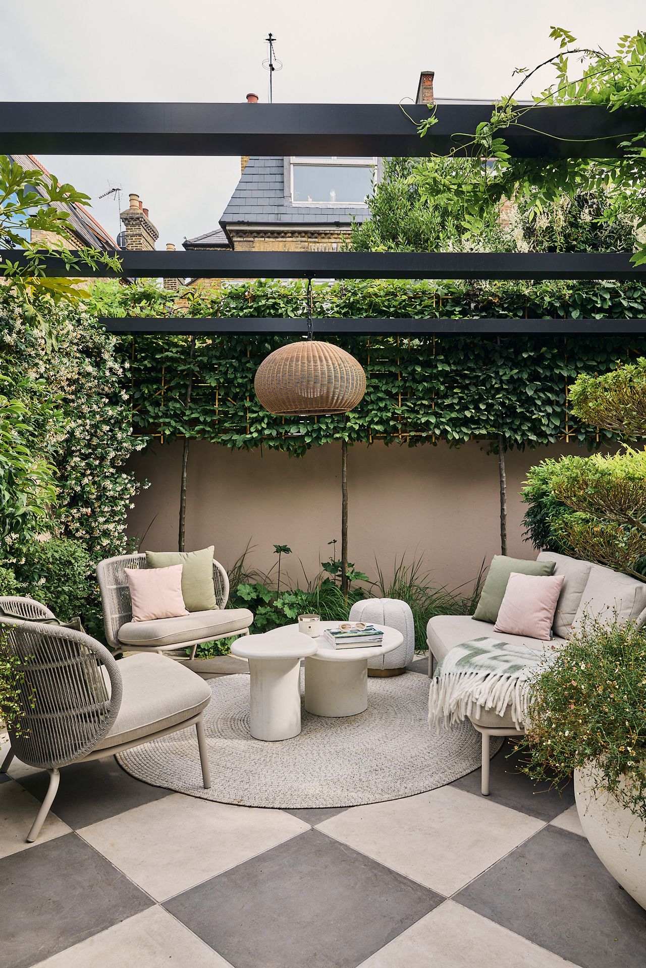a modern garden filled with plants with a large checkerboard floor and living room furniture