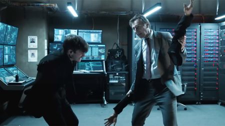 Liam Neeson as Frank Drebin Jr. beating a guy with his own detached arms in The Naked Gun