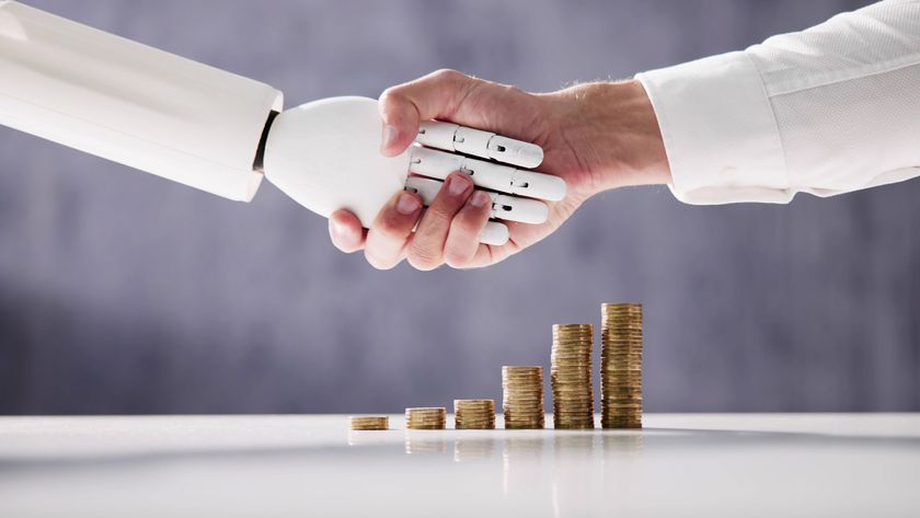 human hand shaking hands with robot hand over coins