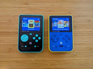 Super Pocket review; two colourful retro consoles on a wooden table