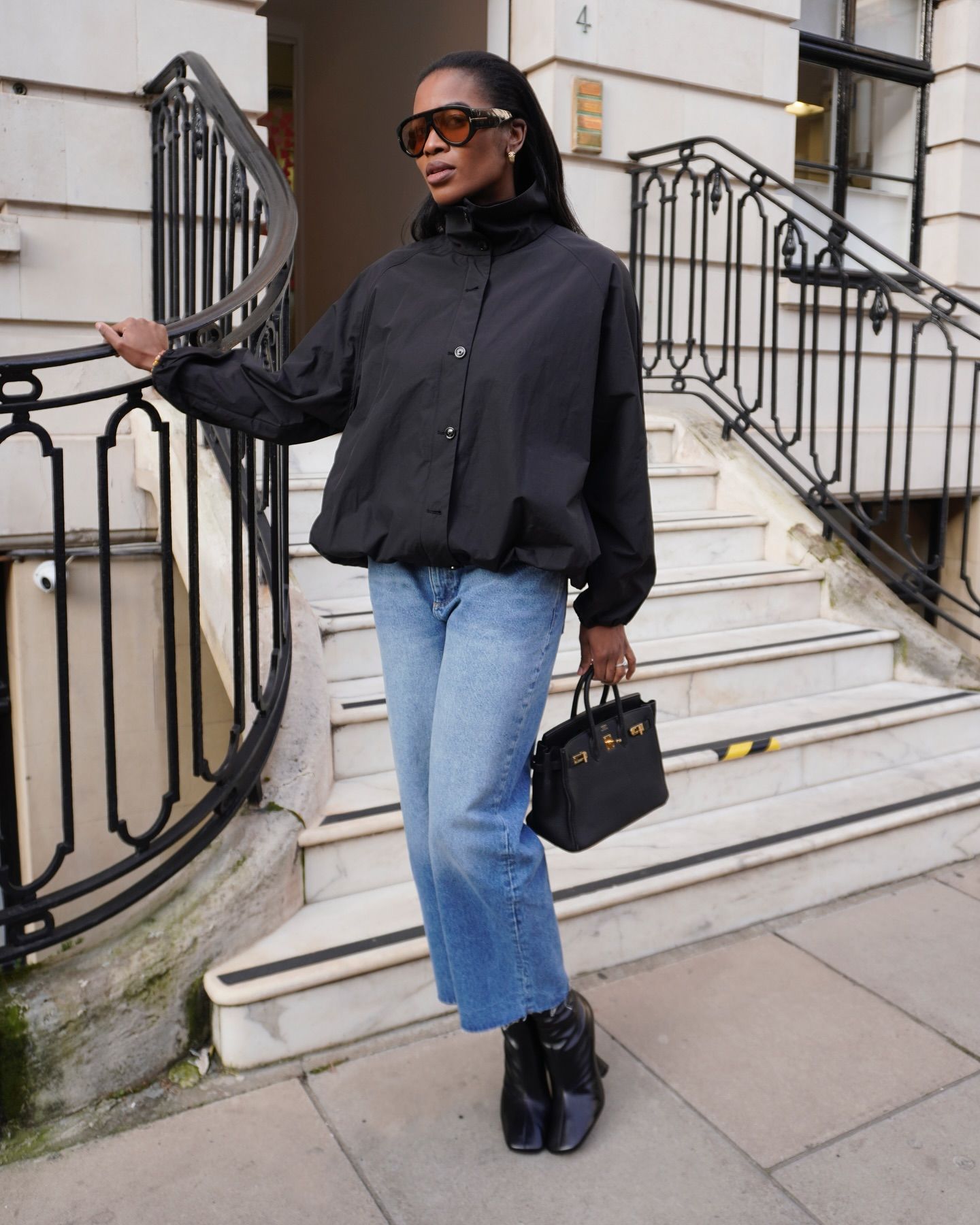 Woman in black technical jacket and jeans.