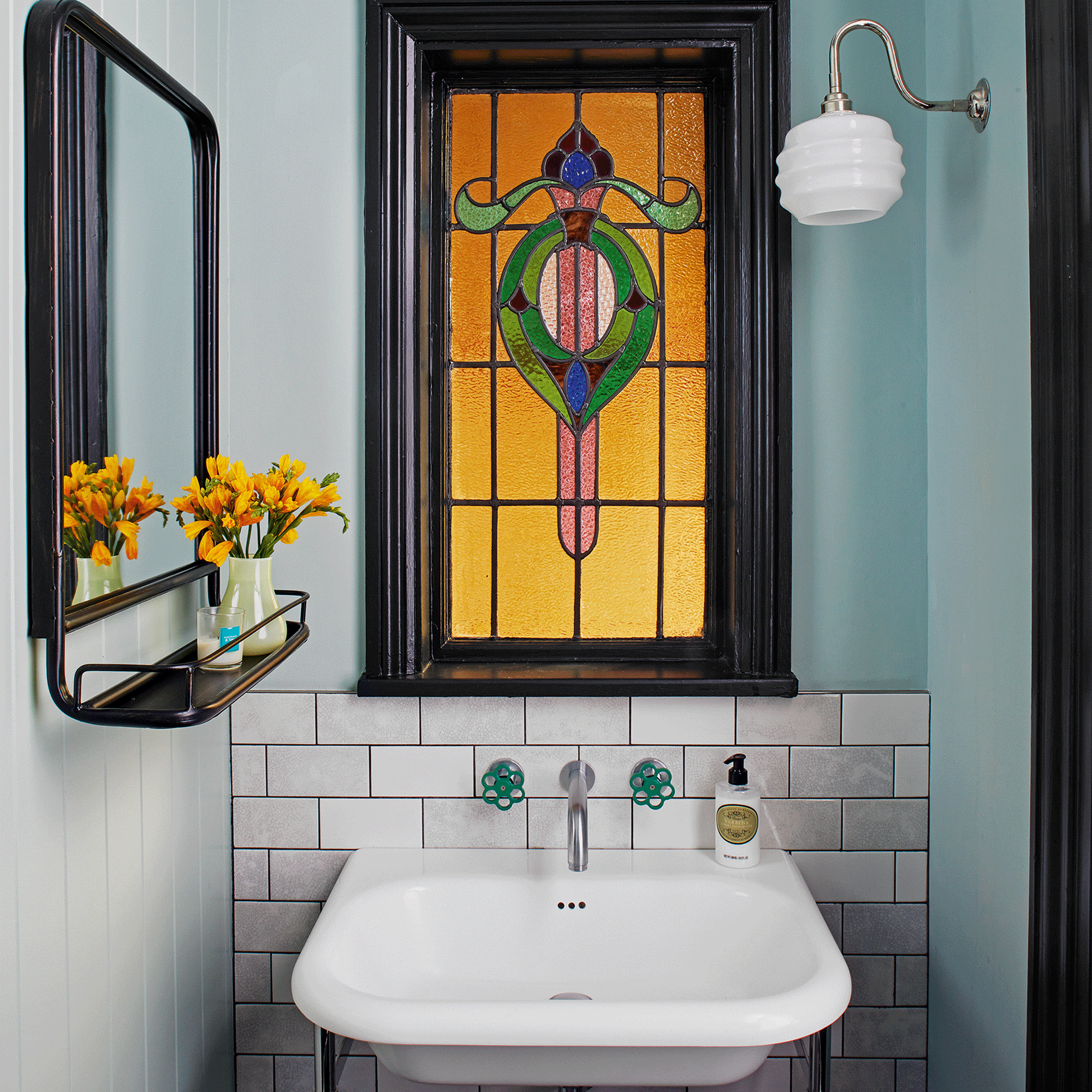 Blue bathroom with stained glass window