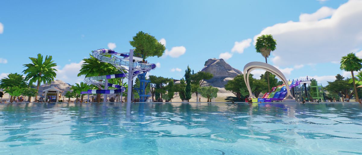 A rippling pool with flumes and tropical plants in the background.