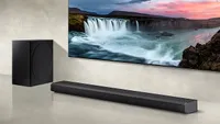 the Samsung HW-Q800A soundbar beside a subwoofer and below a TV screen showing an image of a waterfall