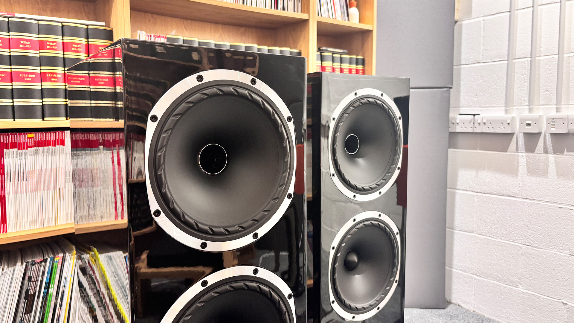 Fyne Audio F502S floorstanding speakers in front of bookcase focus on drive units