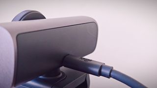 A Graphite-coloured Logitech MX Brio webcam sitting on top of a monitor