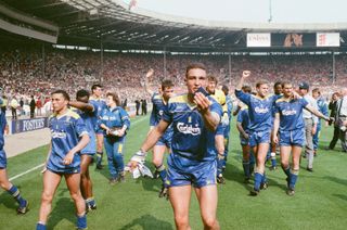 Wimbledon players, led by Vinnie Jones, celebrate their shock victory over Liverpool in the 1988 FA Cup final at Wembley Manchester United