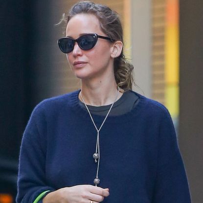 Jennifer Lawrence wore jeans and The Row slippers with a neon green bag, which tapped into the French girl-approved color trend