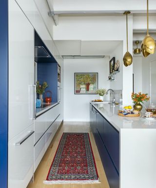 white and blue gloss kitchen with vintage runner
