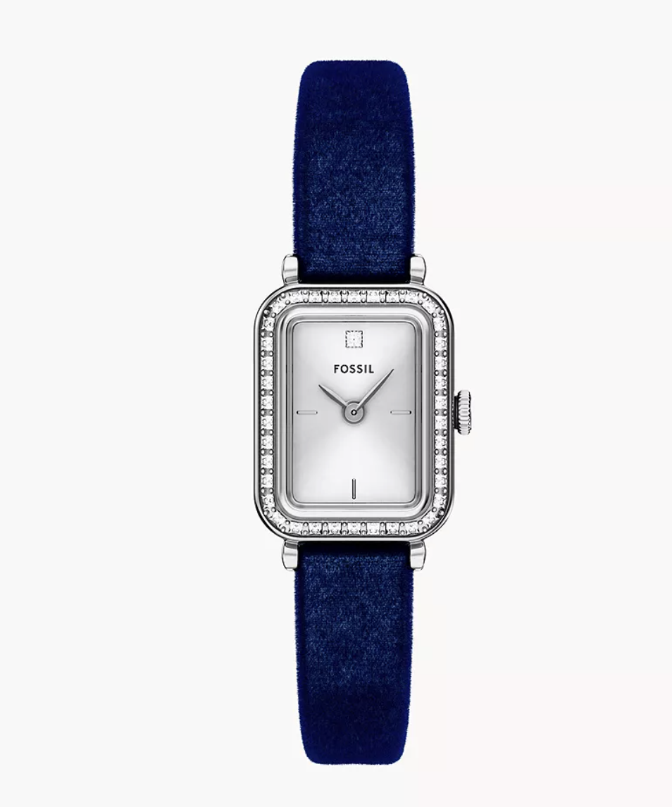 silver watch on blue velvet strap