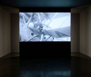 Large screen showing a black and white image of a plane