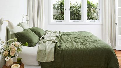 Linen bed sheets in green on a double bed