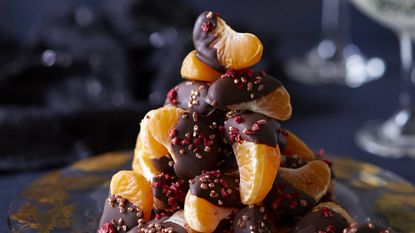 Clementine chocolates with raspberries and gold crunch decoration