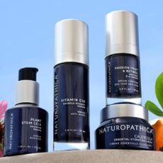 A collection of Naturopathica products on a light blue background. 