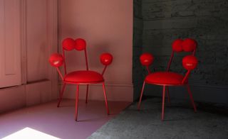 red chairs against a pink and black wall