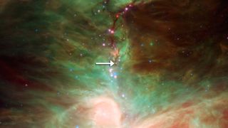 This image taken of the Orion nebula by NASA's infrared Spitzer Space Telescope shows the location of the infant star HOPS-68, which a new study reveals is subjected to a crystal rain of olivine minerals.