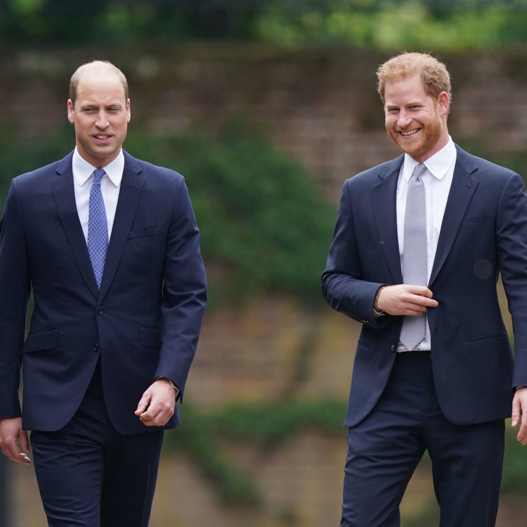 Prince William and Prince Harry walking in blue suits at Kensington Palace