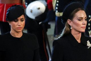 Catherine, Princess of Wales and Meghan, Duchess of Sussex attend as the coffin of Britain's Queen Elizabeth arrives at Westminster Hall from Buckingham Palace for her lying in state, on September 14, 2022 in London, United Kingdom. Queen Elizabeth II's coffin is taken in procession on a Gun Carriage of The King's Troop Royal Horse Artillery from Buckingham Palace to Westminster Hall where she will lay in state until the early morning of her funeral. Queen Elizabeth II died at Balmoral Castle in Scotland on September 8, 2022, and is succeeded by her eldest son, King Charles III.
