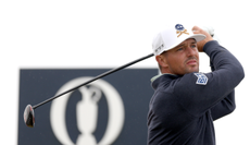 Bryson DeChambeau watches his tee shot after striking a driver