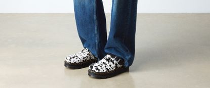 Person wearing cow print shoes 