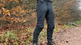 A rider wearing rapha men's trail pants at the side of a trail