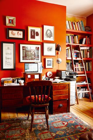 traditional home office with orange walls