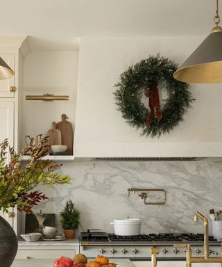 A range hood decorated with a Christmas wreath