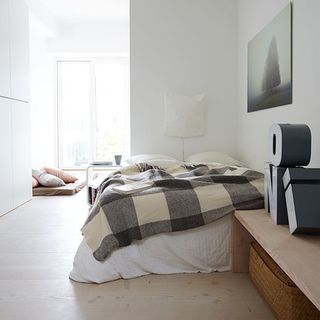 bedroom with low level bed and wall light