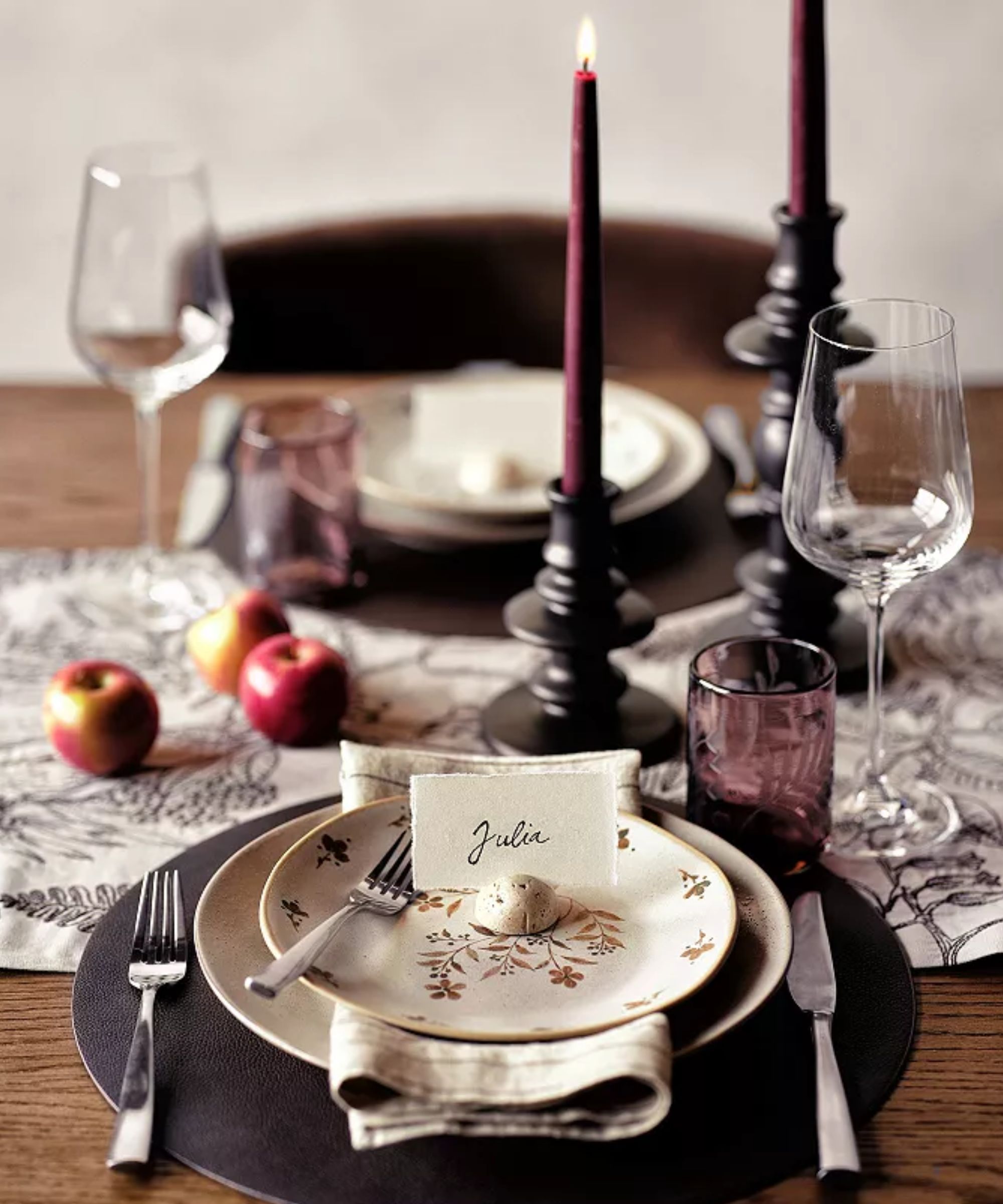 Tablescape with floral plates, brown chargers and purple glassware