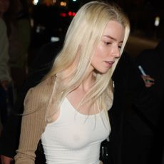 Anya Taylor-Joy elevated a plain white tank top with a satin skirt, a fur-trimmed bolero, and square-toe kitten heels