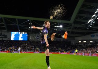 Harry Kane celebrates his goal by kicking a bottle