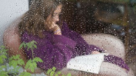 Woman reading in the rain