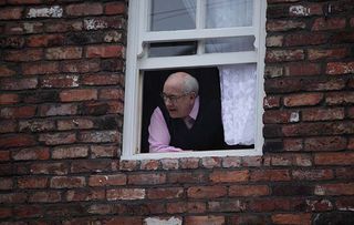 Norris Cole pokes his head out of number three Coronation Street