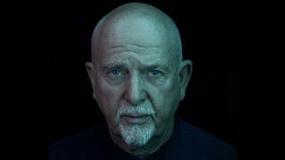 Peter Gabriel headshot for 2023 with blue lighting against a black background